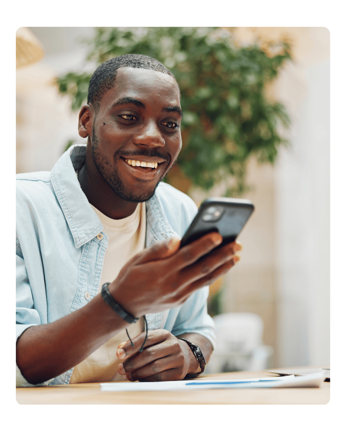 Smiling man checking his credit on the Dovly AI app on his phone