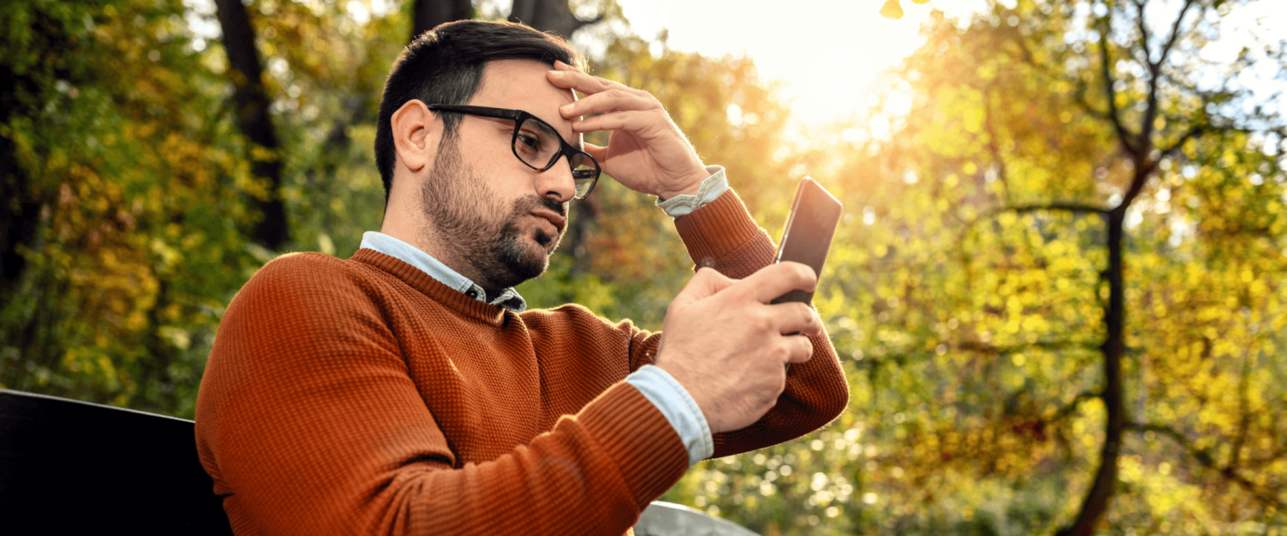 A man getting a notification that his credit score dropped 30 points