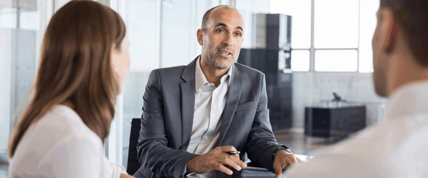 A couple talking to an agent about building business credit with bad personal credit.