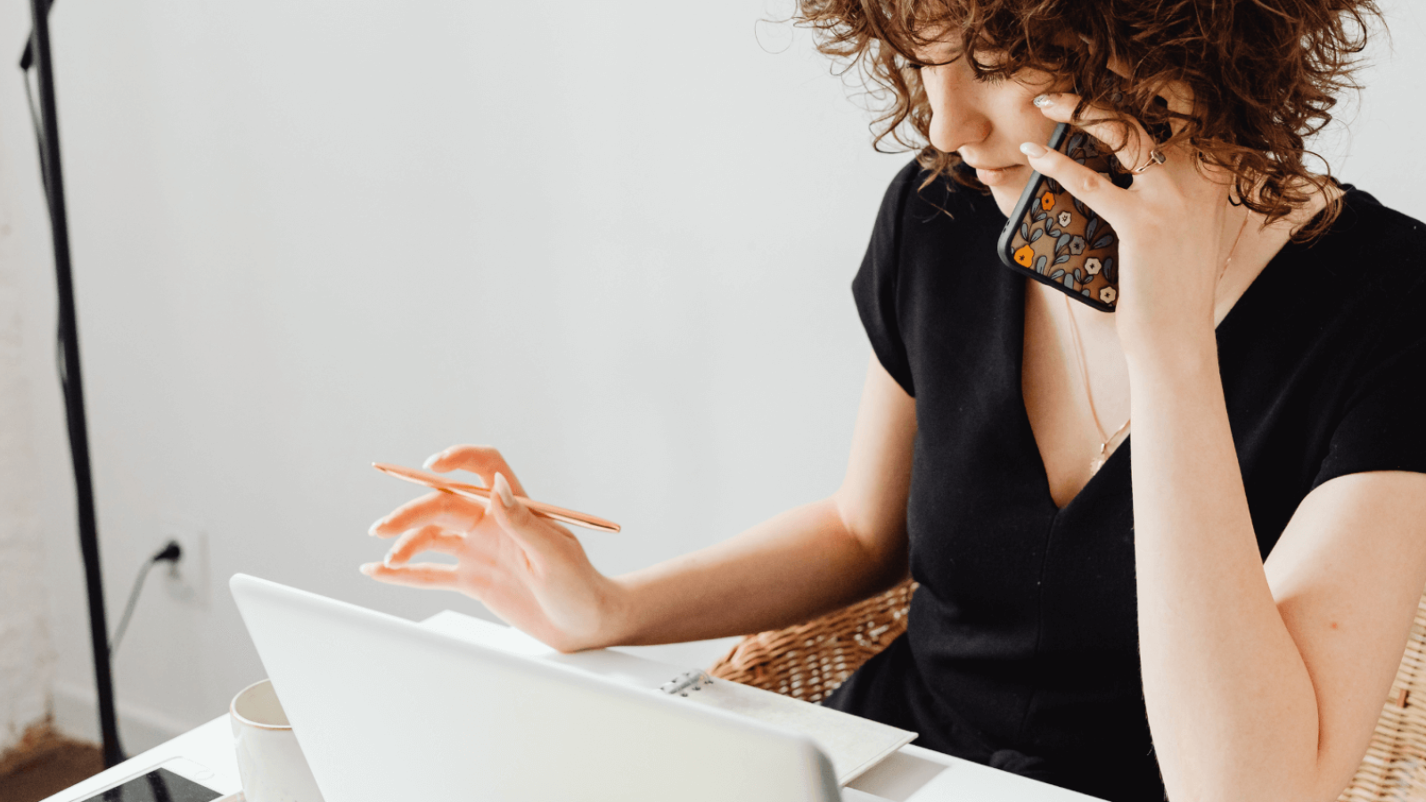 Woman on the phone looking into her finances.