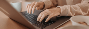 A woman using a laptop to check her credit score.