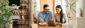 A couple looking at their finances together on a laptop.