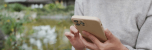 Person checking their phone to look at their credit score.