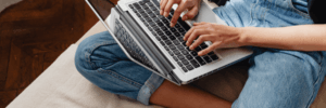 A woman on her laptop, researching how to manage a 636 credit score.