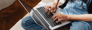 Woman on using her laptop to do research on credit scores. 