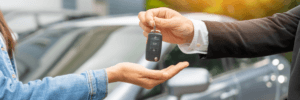 Person getting a car at the dealership with a 600 credit score.