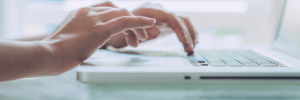 A person looking up credit monitoring services on their laptop.