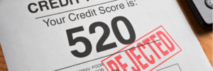 A credit report with a 520 credit score, being rejected.