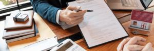 Talking to an agent about what's needed to purchase a home.