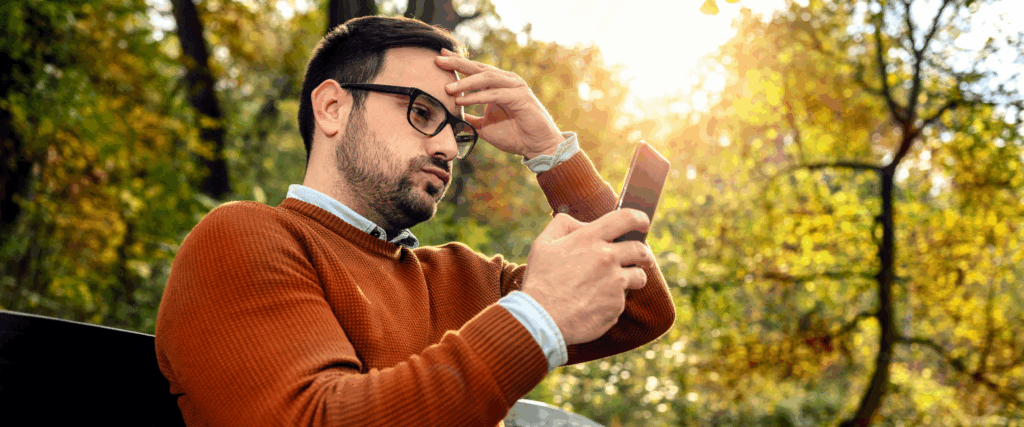 A man getting a notification that his credit score dropped 30 points